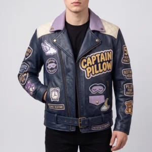 Male model wearing navy blue Captain Pillow leather biker jacket with lavender lapels, sleep-themed chest patches, and a buckled waist belt.